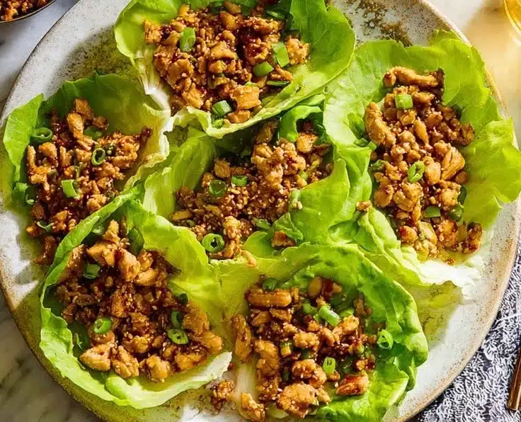 Plate of PF Chang's Chicken Lettuce Wraps served with dipping sauce