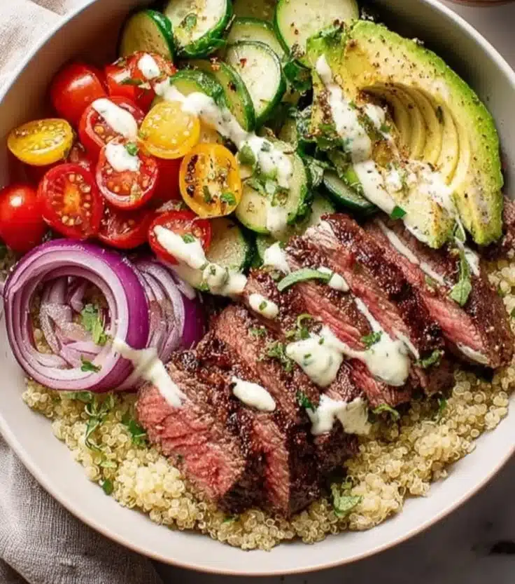 Healthy Steak Quinoa Bowl with grilled steak, fresh veggies, and quinoa.