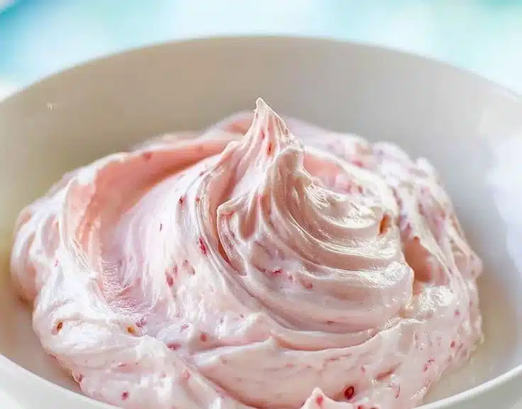 Delicious strawberry marshmallow frosting on a cupcake