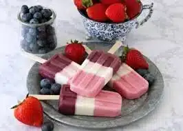 A variety of delicious summer treats including ice cream, fruit popsicles, and sorbet.