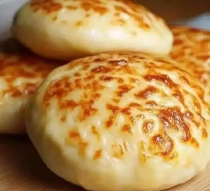 Freshly baked cheese bread with golden crust and gooey cheese inside