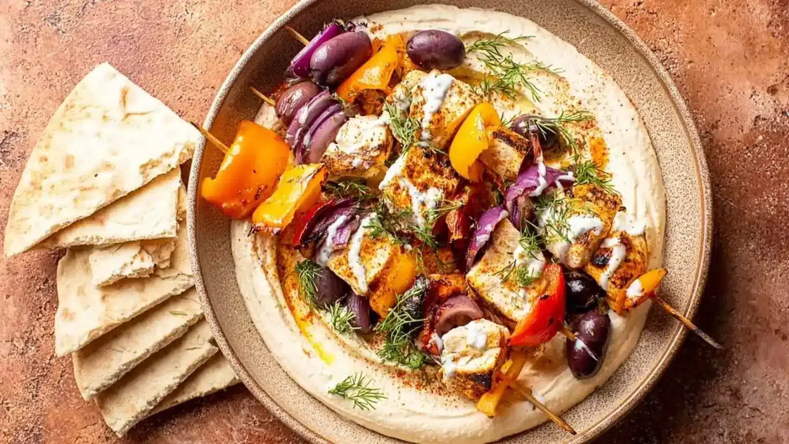 Delicious Chicken Souvlaki served with fresh vegetables and tzatziki sauce