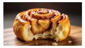 Cinnamon roll cupcakes with creamy frosting on a white plate
