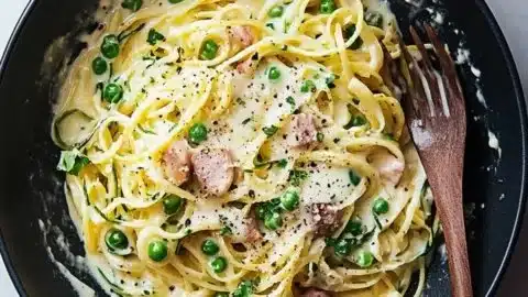 Delicious creamy carbonara served with zoodles and garnished with parsley.