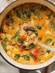 Bowl of creamy Cheese Tortellini Soup garnished with herbs