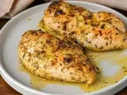 Delicious easy baked chicken breast served with fresh herbs and vegetables