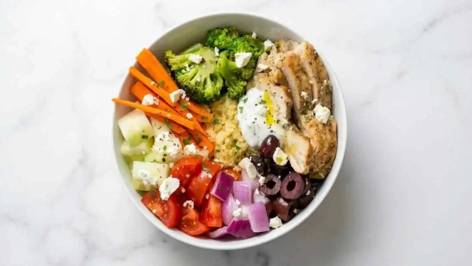 Delicious Greek Chicken Couscous Bowl with fresh vegetables and herbs