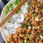 Variety of healthy ground chicken recipes on a wooden table