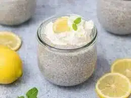 Bowl of healthy lemon chia seed pudding garnished with fresh lemon and chia seeds