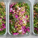 High protein meal prep salad with chicken, veggies, and dressing in a bowl.