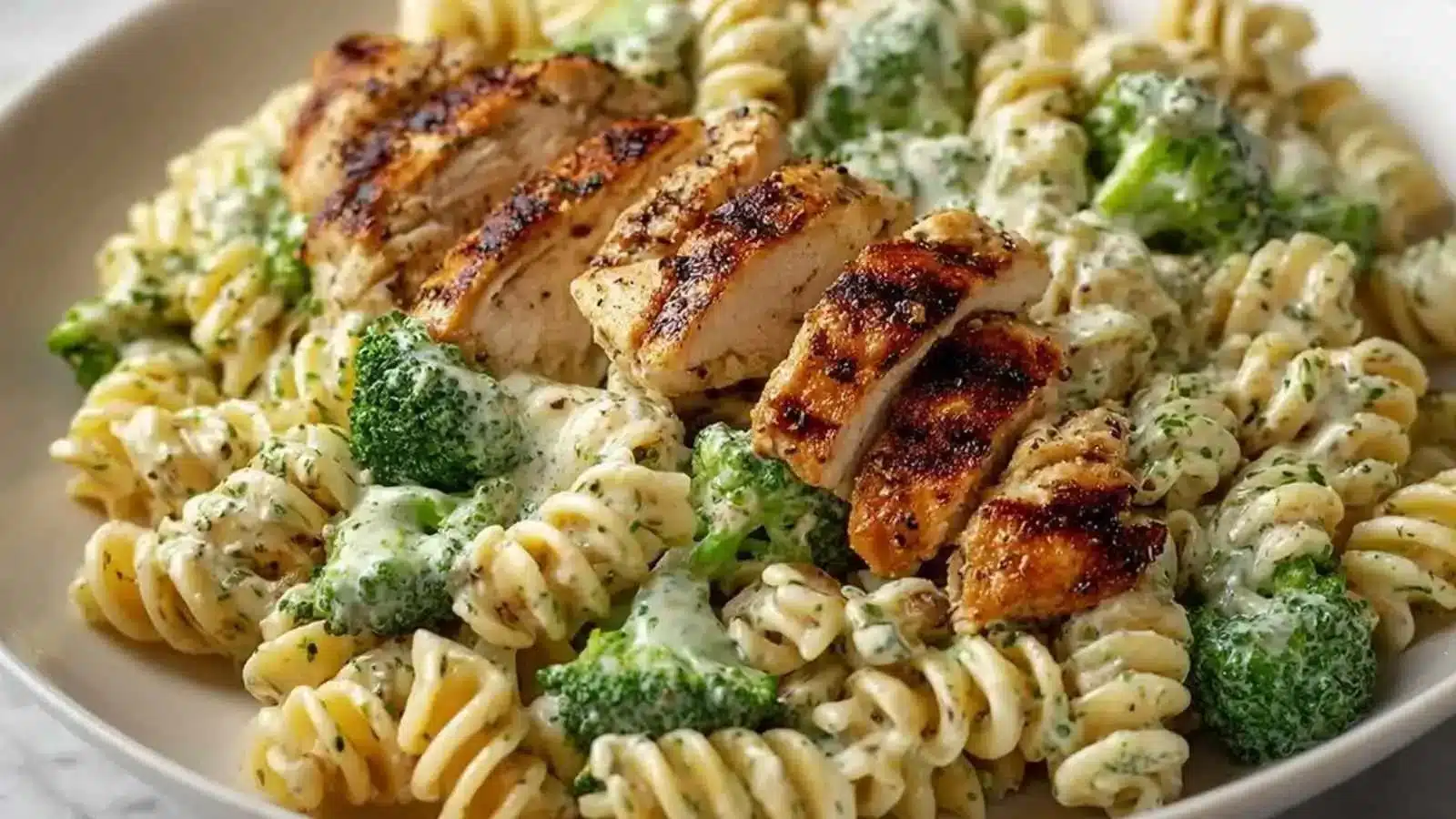High Protein Rotisserie Chicken Broccoli Pasta dish with vibrant colors and textures.