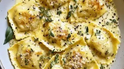 Creamy Lemon Herb Butter Ravioli served with fresh herbs and lemon zest