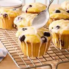 Freshly baked lemon blueberry muffins on a cooling rack