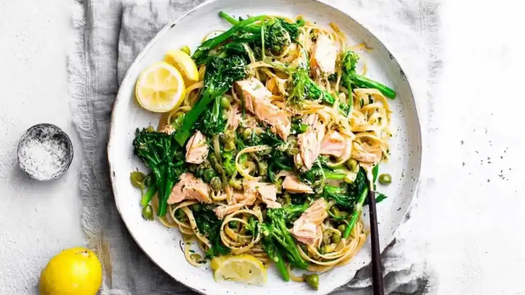 Plate of Lemony Salmon Pasta garnished with herbs and lemon slices