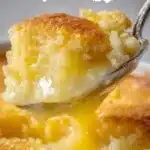 Magic Lemon Cobbler dessert served in a dish with lemon slices