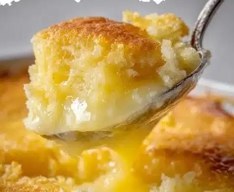 Magic Lemon Cobbler dessert served in a dish with lemon slices