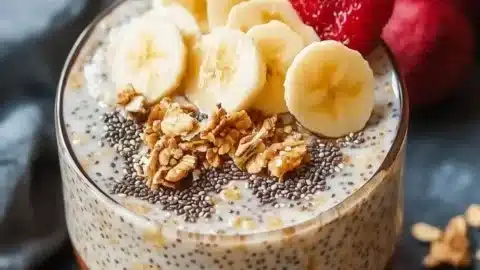 Bowl of maple cinnamon overnight oats topped with chia seeds and fruit.