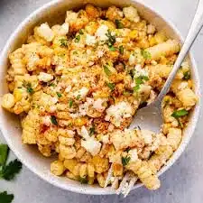 Bowl of Mexican Street Corn Pasta Salad with fresh ingredients and vibrant colors.