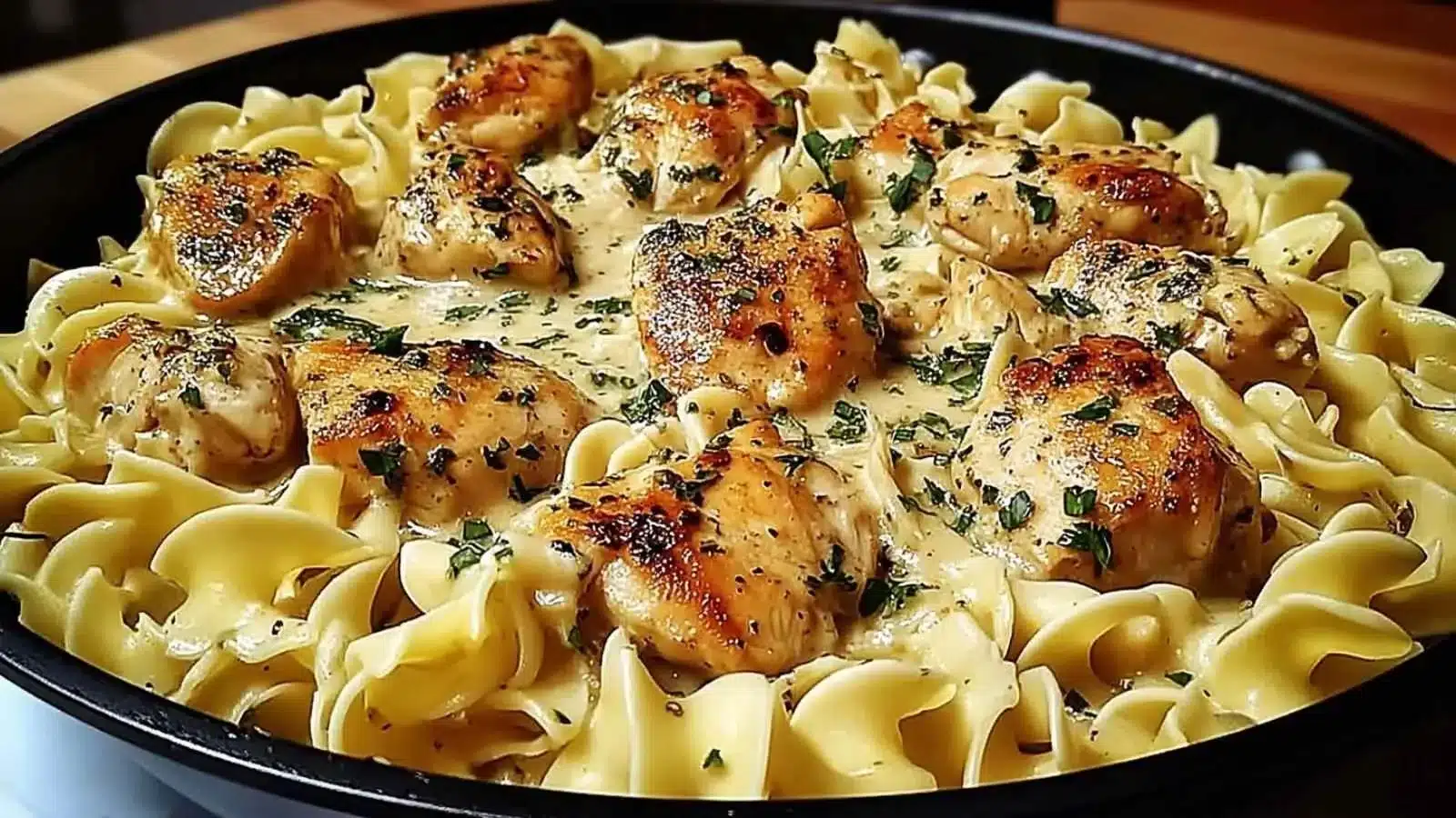 One Pan Creamy Garlic Butter Chicken served with egg noodles in a savory garlic sauce.