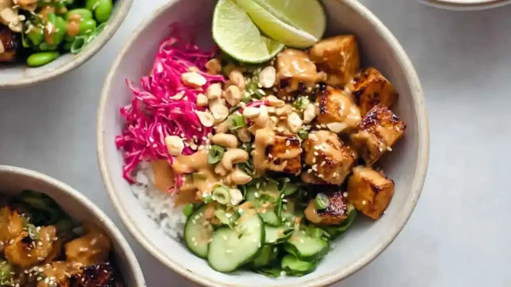 Peanut Tofu Bowls served with fresh vegetables and a savory sauce