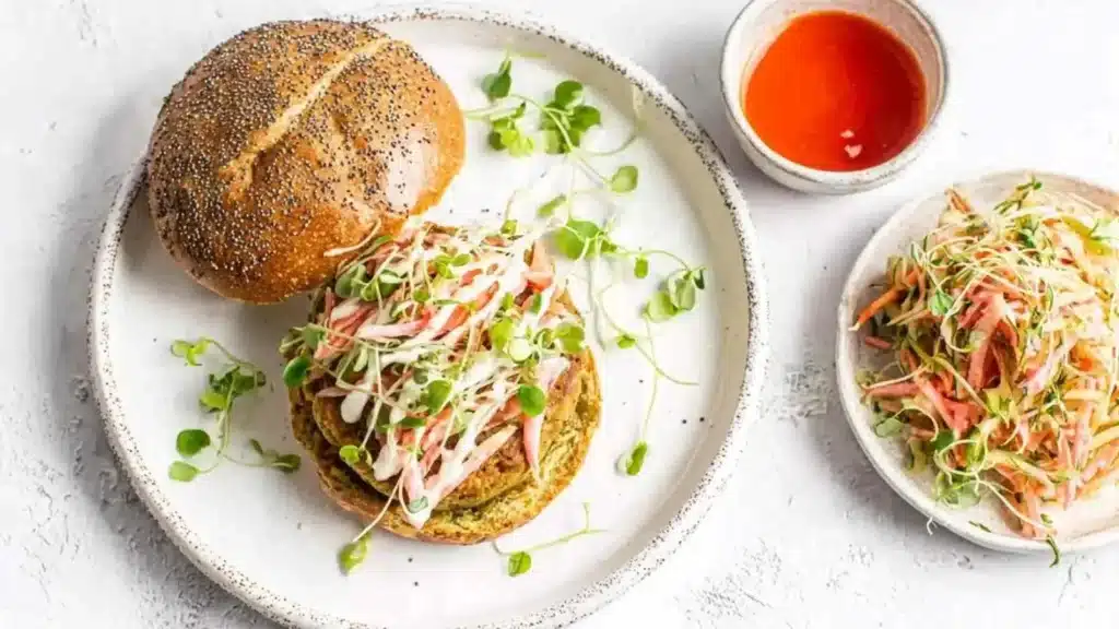 Delicious salmon burgers with spicy sriracha slaw on a plate