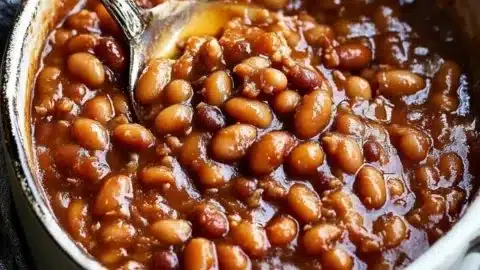 Delicious plate of homemade canned baked beans garnished with herbs