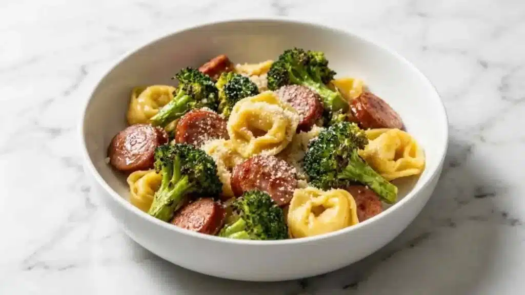 Delicious Sheet Pan Sausage Tortellini served with fresh vegetables