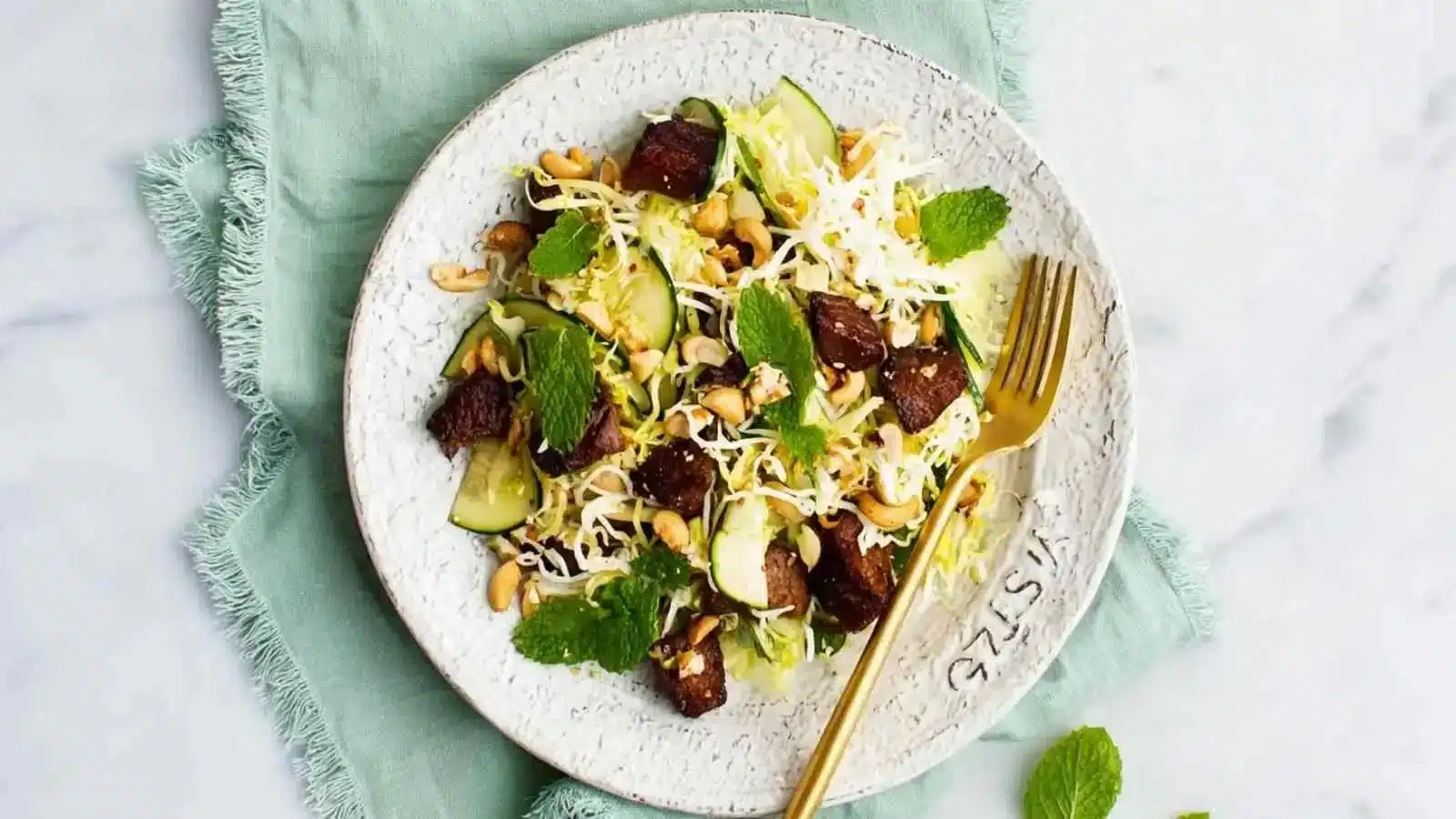 Spicy tempeh and rice noodle salad garnished with fresh vegetables
