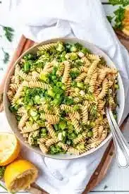 Colorful Vegan Summer Pasta Salad with fresh vegetables and herbs