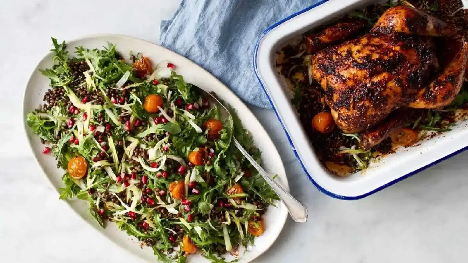Delicious roast chicken served with a fresh lentil salad on a wooden table.