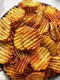 Air fryer spicy dill pickle chips arranged on a plate