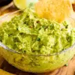 Bowl of authentic guacamole with fresh ingredients and tortilla chips