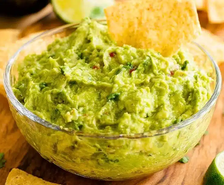 Bowl of authentic guacamole with fresh ingredients and tortilla chips