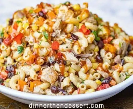 Delicious BBQ Chicken Pasta Salad topped with fresh ingredients and barbecue sauce.