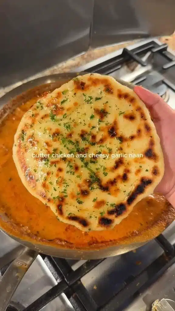 Butter Chicken Cheesy Garlic Naan with creamy sauce and melted cheese