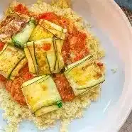 Delicious eggplant recipe showcasing roasted slices garnished with herbs.