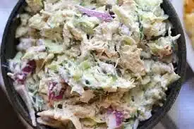 Bowl of delicious tzatziki chicken salad with fresh vegetables and chicken.