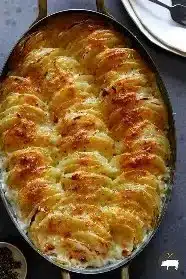 Creamy and delicious fancy potato bake topped with cheese and herbs