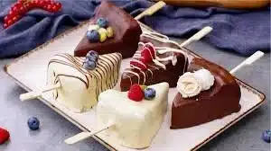 Delicious frozen cheesecake pops on a stick, perfect summer treat.
