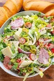 Delicious and colorful Grinder Salad with fresh vegetables and dressing
