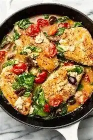 Healthy Mediterranean chicken dish with colorful vegetables and spices.