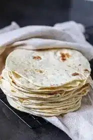 Freshly made homemade tortillas on a wooden table