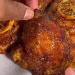 Honey Garlic Lemon Pepper Chicken Thighs served on a plate with garnish