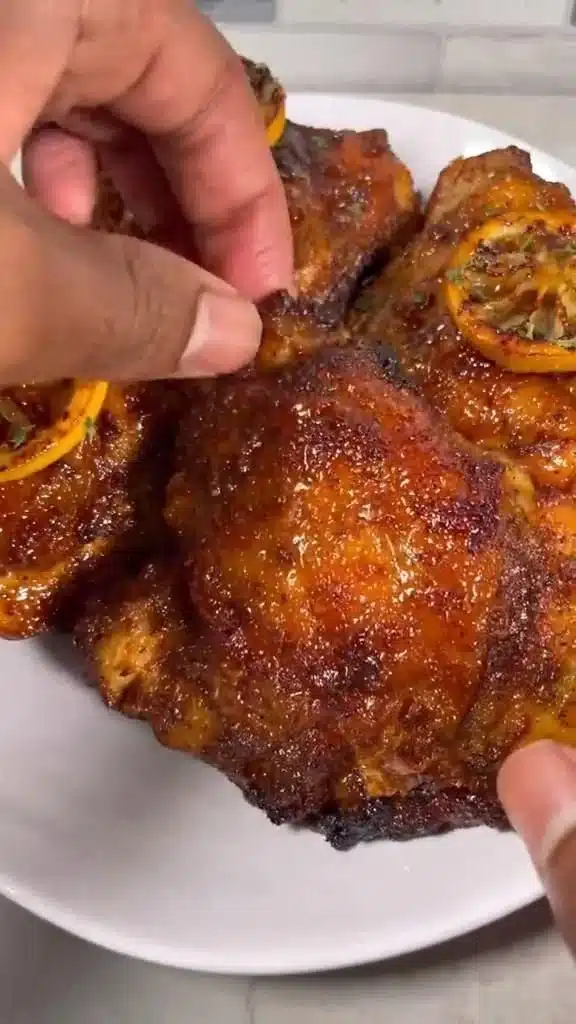 Honey Garlic Lemon Pepper Chicken Thighs served on a plate with garnish