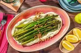 Plate of roasted asparagus and carrots seasoned for a festive meal