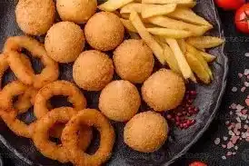 Golden brown fried snacks on a plate, bursting with flavor and crispy texture.