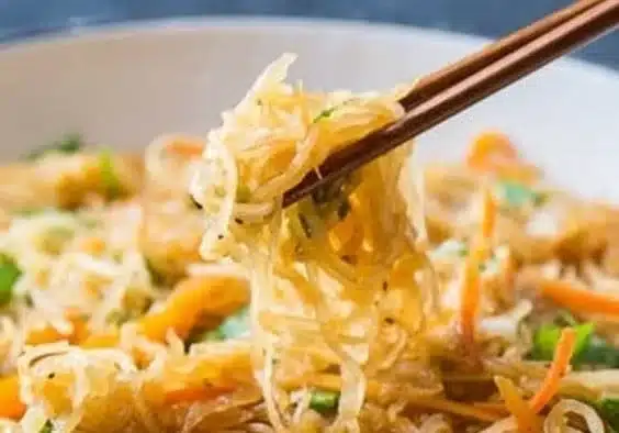 Spaghetti squash dish topped with protein and colorful vegetables