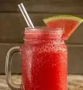 Refreshing watermelon lemonade slush in a glass with ice and lemon slices