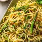Zesty lemon asparagus pasta dish garnished with herbs in a bowl