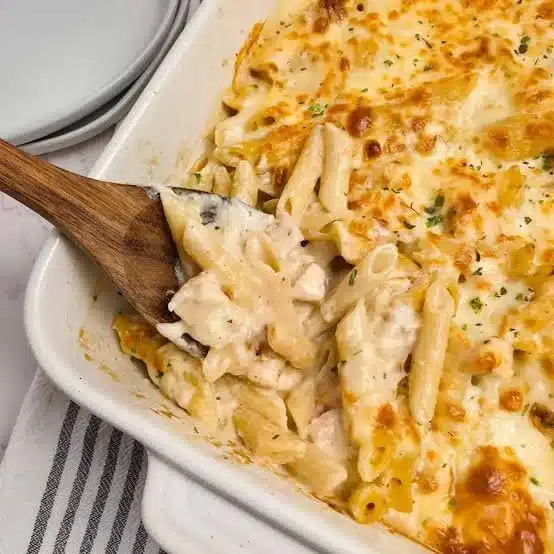 Delicious Chicken Alfredo Bake served in a casserole dish with melted cheese on top